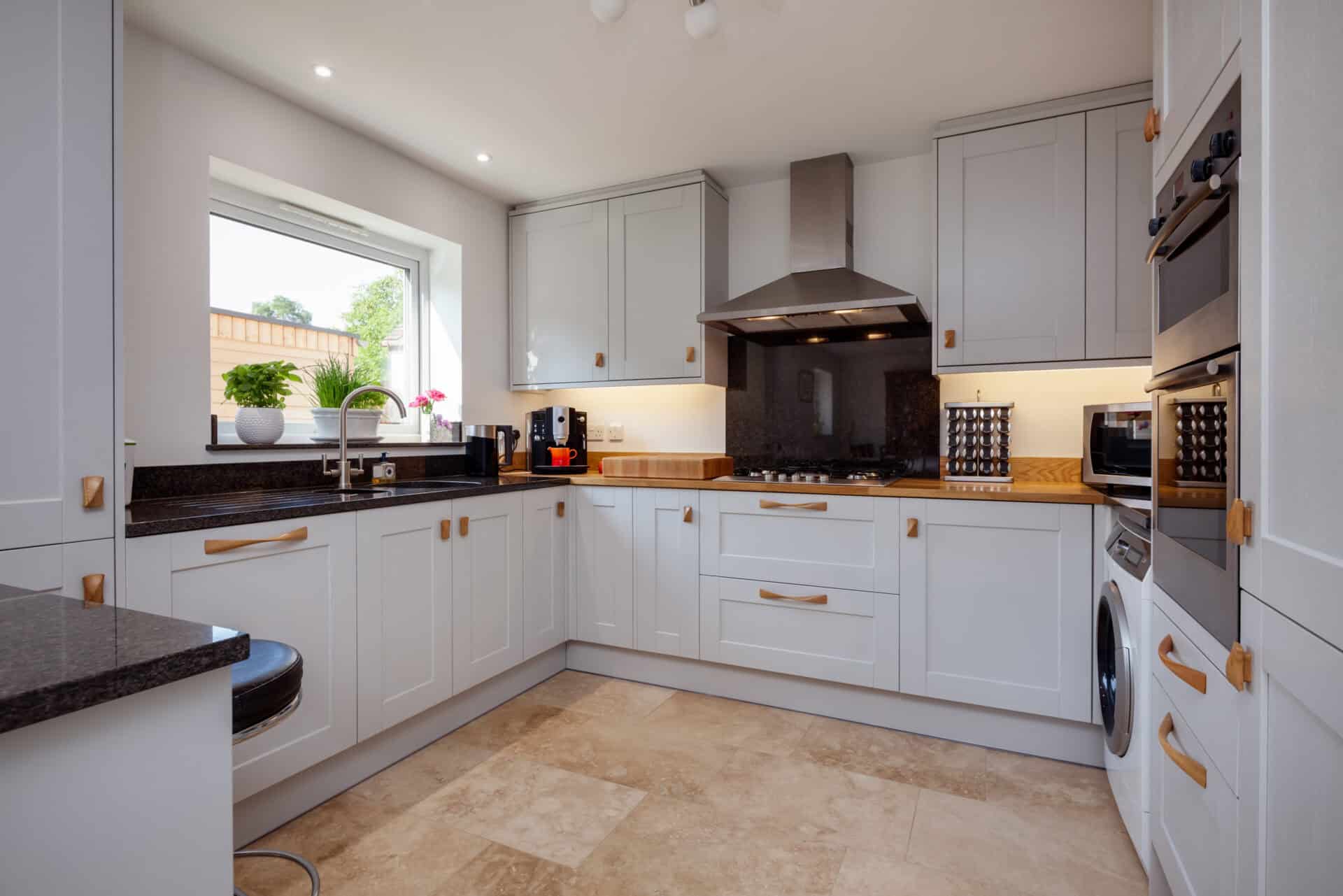 Modern contemporary shaker style fitted kitchen with built in appliances breakfast bar and granite counbter tops